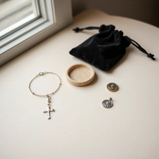 Catholic jewelry gifts displayed neatly, including rosary bracelet and cross pendant