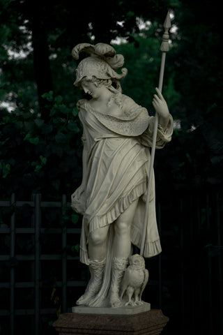 a statue of a person holding a staff