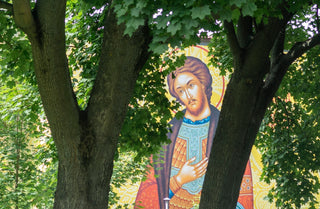 A painting of a woman holding a baby in a park