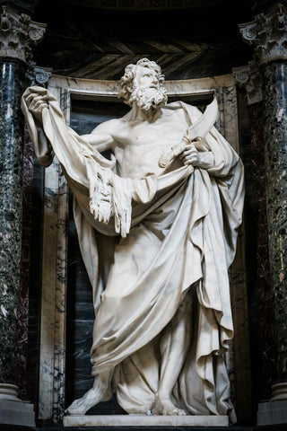 A marble statue of saint bartholomew with a knife.