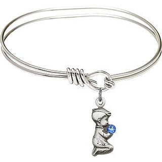 5 3/4 inch Oval Eye Hook Rhodium Bangle Bracelet with a Sterling Silver Praying Boy charm.