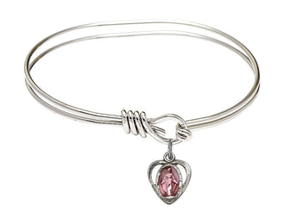 5 3/4 inch Oval Eye Hook Rhodium Bangle Bracelet with a Sterling Silver Miraculous charm.