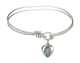5 3/4 inch Oval Eye Hook Rhodium Bangle Bracelet with a Sterling Silver Miraculous Heart charm.