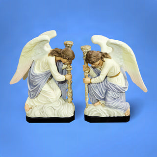 A matched set of hand-painted angel statues with wings and flowing robes, cast in fiberglass resin.