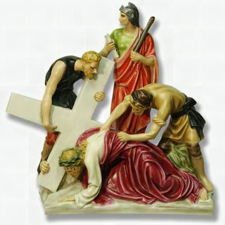Hand-painted statue of Jesus falling beneath the weight of the cross, the second station of the Passion.