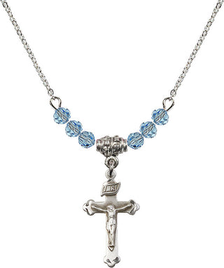 18" Rhodium Plated Necklace with 4mm Aqua Crystal Beads featuring a Sterling Silver Crucifix Medal.