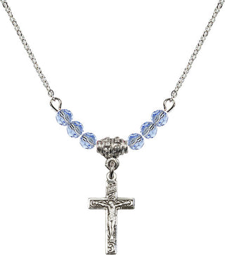 18" Rhodium Plated Necklace with 4mm Light Sapphire Crystal Beads featuring a Sterling Silver Crucifix Medal.