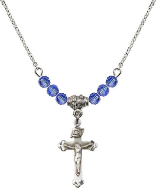 18" Rhodium Plated Necklace with 4mm Sapphire Crystal Beads featuring a Sterling Silver Crucifix Medal.