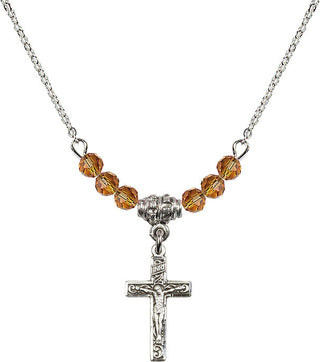 18" Rhodium Plated Necklace with 4mm Topaz Crystal Beads featuring a Sterling Silver Crucifix Medal.
