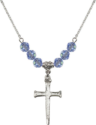 18" Rhodium Plated Necklace with 4mm Light Sapphire Crystal Beads featuring a Sterling Silver Nail Cross Medal.