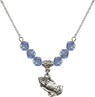 18" Rhodium Plated Necklace with 4mm Light Sapphire Crystal Beads featuring a Sterling Silver Praying Hands Medal.