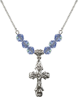 18" Rhodium Plated Necklace with 4mm Light Sapphire Crystal Beads featuring a Sterling Silver Crucifix Medal.