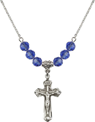 18" Rhodium Plated Necklace with 4mm Sapphire Crystal Beads featuring a Sterling Silver Crucifix Medal.