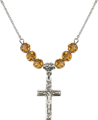 18" Rhodium Plated Necklace with 4mm Topaz Crystal Beads featuring a Sterling Silver Crucifix Medal.