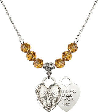 18" Rhodium Plated Necklace with 4mm Topaz Crystal Beads featuring a Sterling Silver Our Lady Guadalupe Heart / Recuerdo Medal.