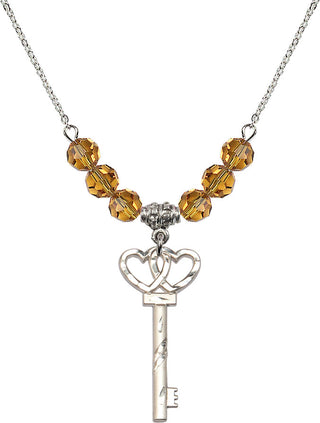 18" Rhodium Plated Necklace with 4mm Topaz Crystal Beads featuring a Sterling Silver Small Key w/Double Hearts Medal.